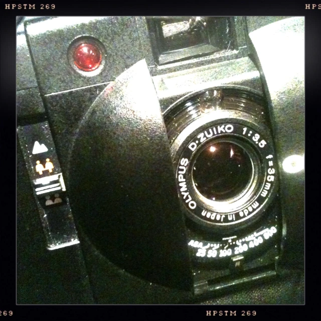 an old analog camera turned upside down with the lens turned down