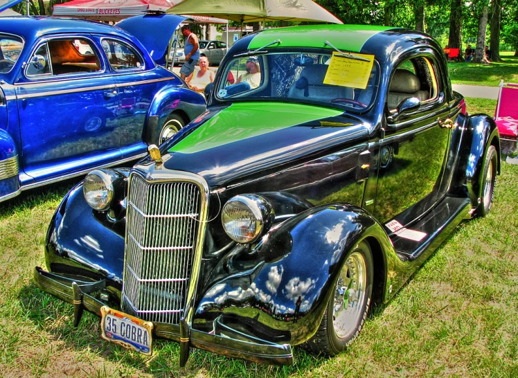 a group of classic cars parked next to each other