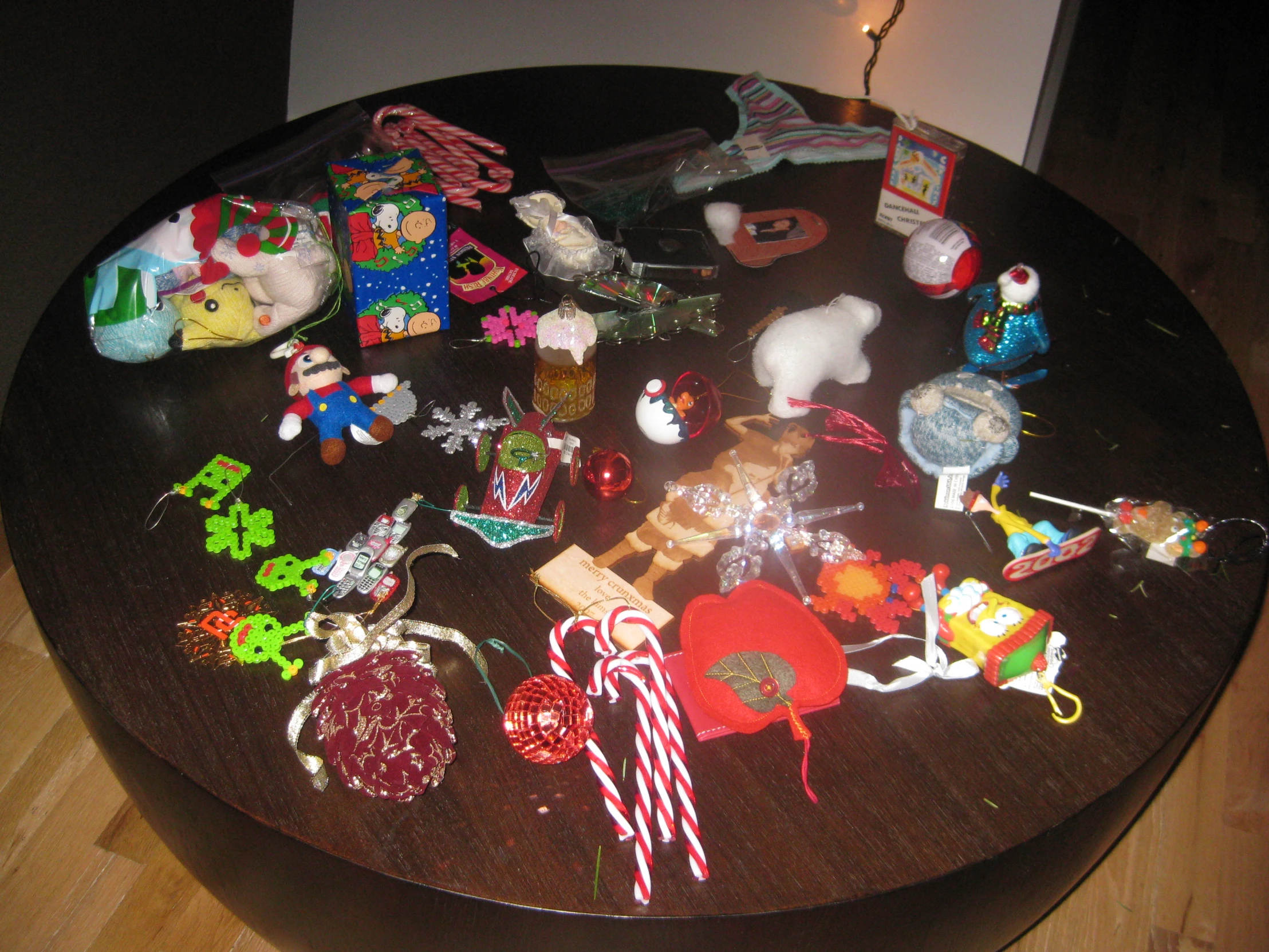 a table topped with lots of ornaments on top of a wooden floor