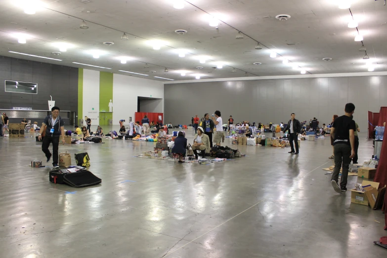 several people walking in a room with luggage