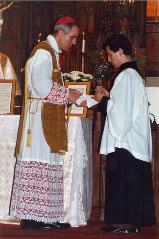 priest at alter of church receiving service from the priest