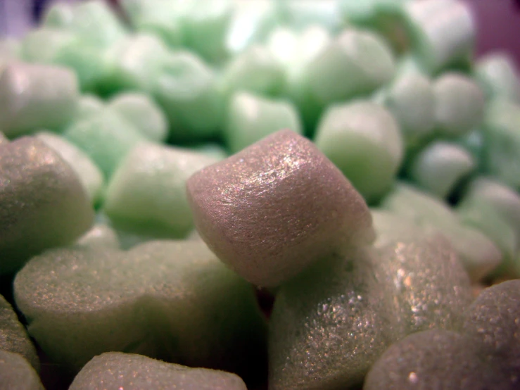 closeup of green and white sweets, which are sugar coated