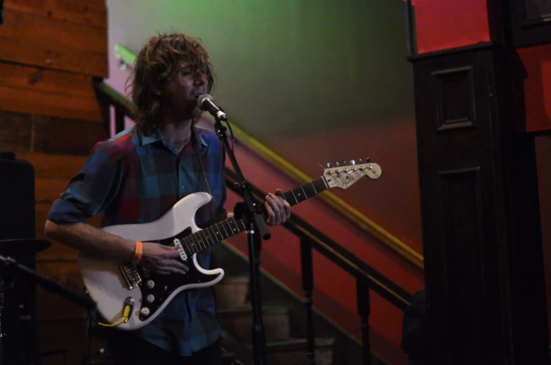 a person on stage with a guitar