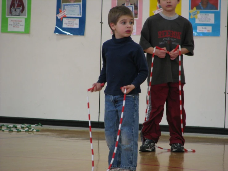 two boys standing in front of a door with paper taped around them