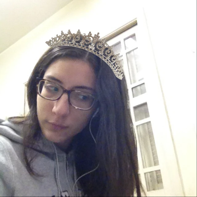 girl with a tiara on and headphones in her ears