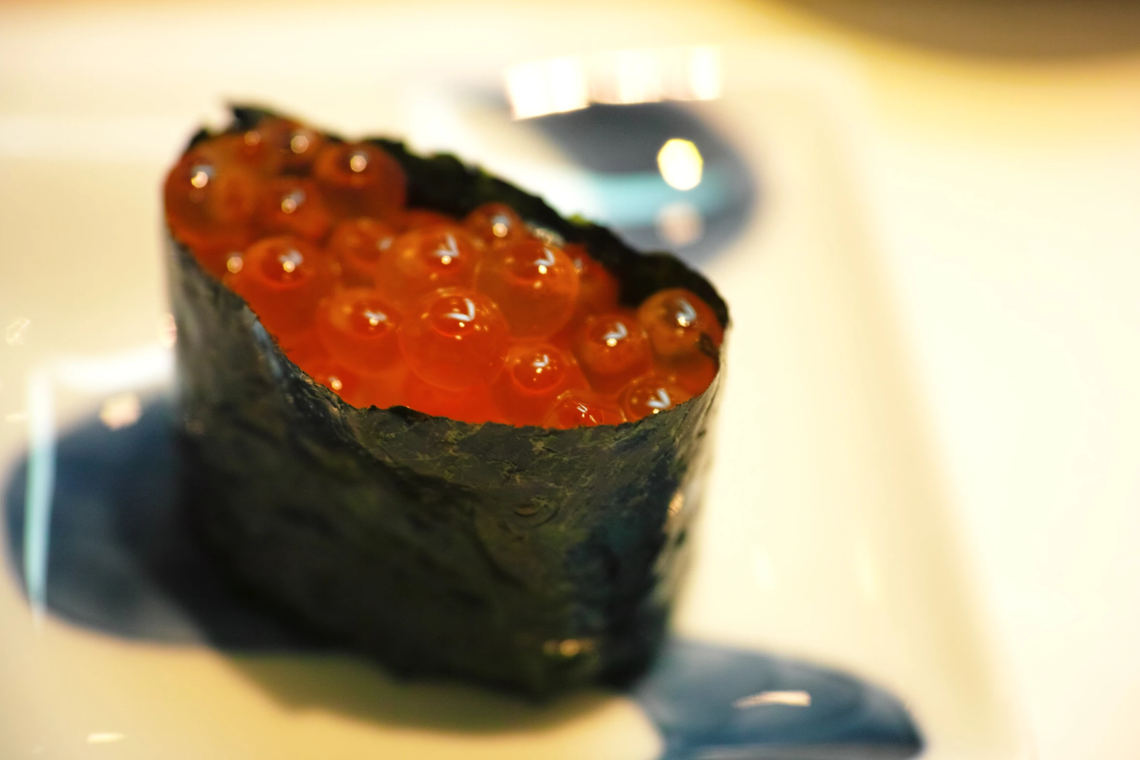 a sushi with jelly sits on a white plate