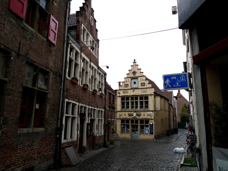 a street is empty with cobblestone roads and old buildings