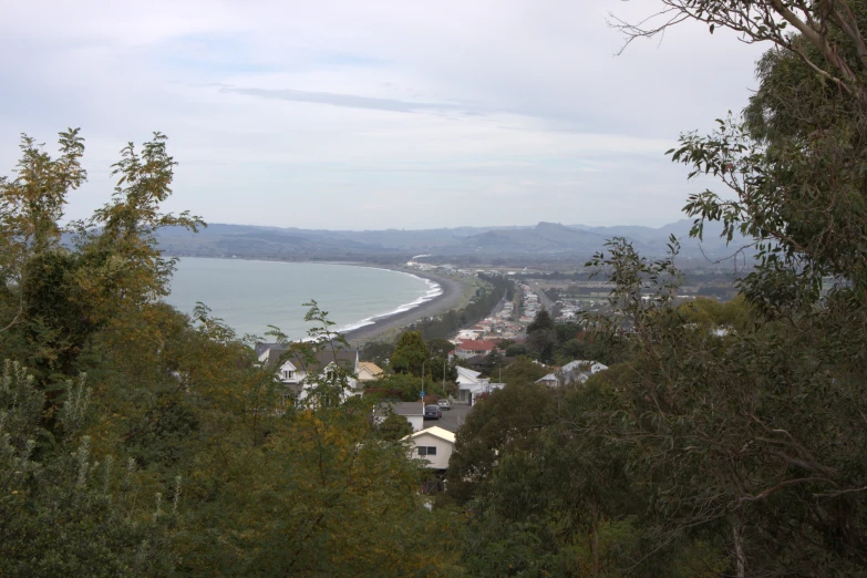 a small town is shown in the foreground, along side an ocean