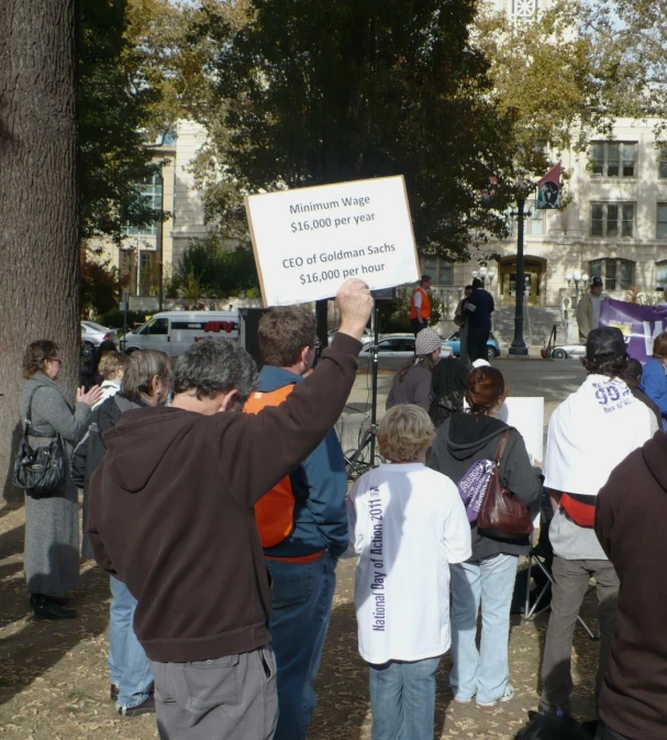people holding up signs while some are standing around