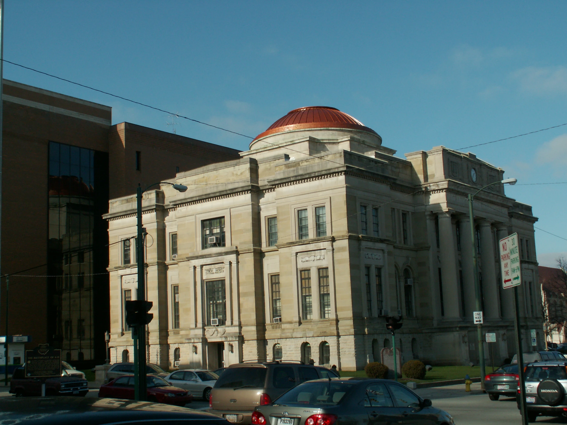 a large tan building on a city street