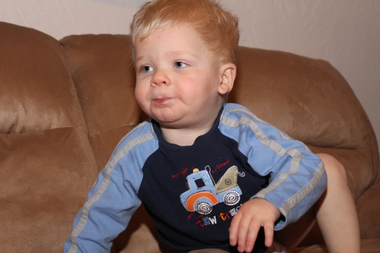 a very cute small  wearing a blue and white shirt