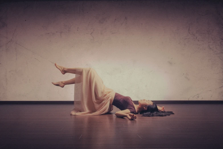 a young woman laying on the floor upside down