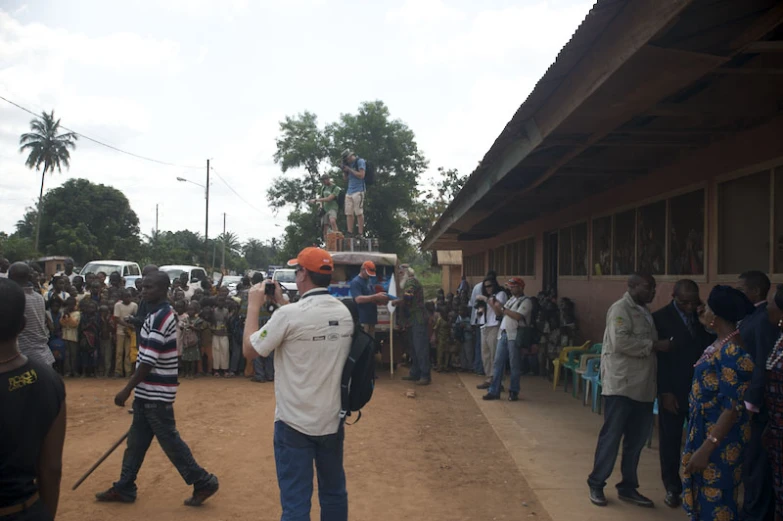 a crowd of people standing around a building