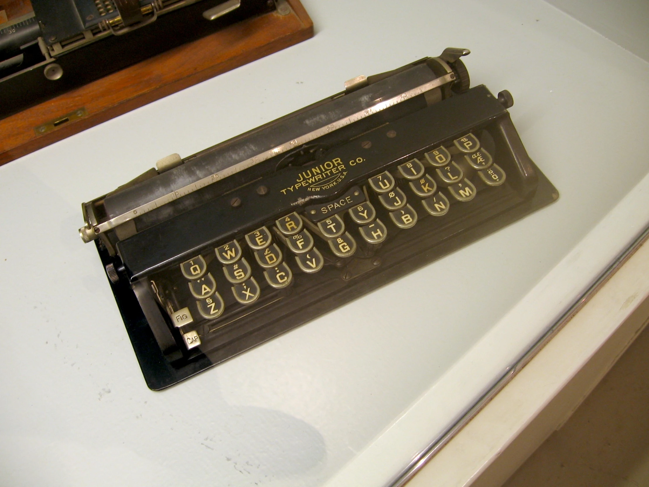 an old typewriter resting on a table with other items around