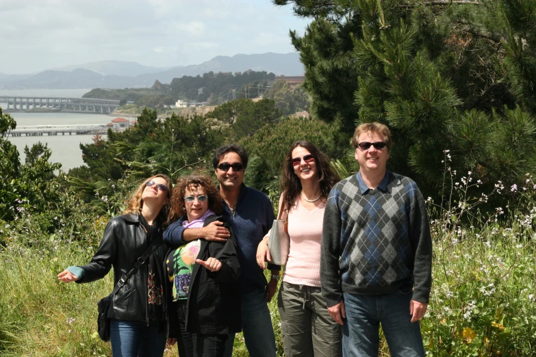 a group of people standing in tall grass