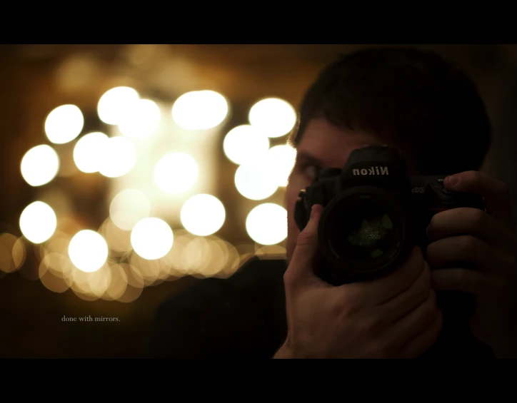 a man holding up a camera to take a picture