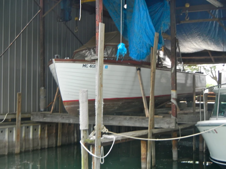 two white and red boats are docked near some dock