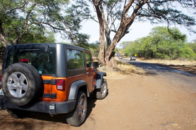 a jeep is parked on a dirt road