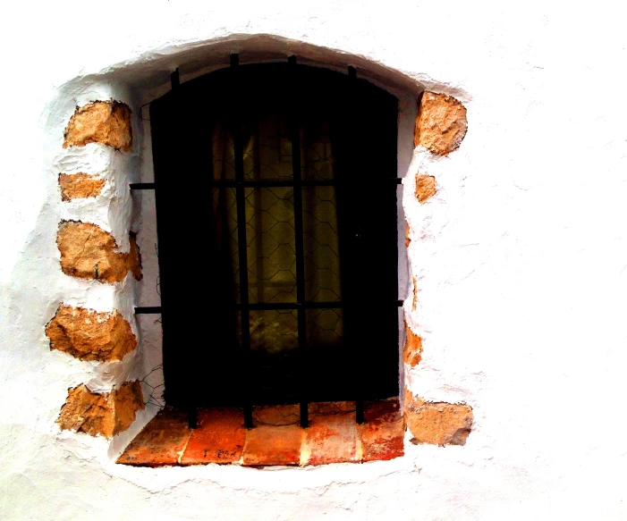 a window with a brown wooden frame on the outside