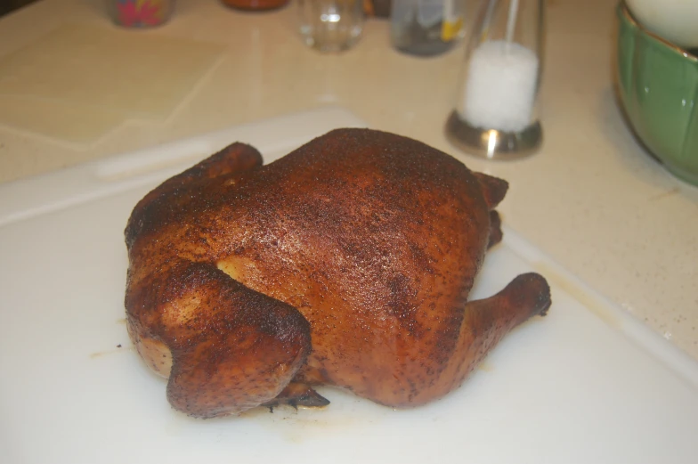 a big chicken is sitting on a white  board