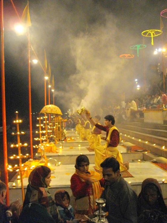 the band plays on stage in a decorated city at night