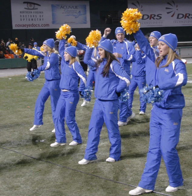 a group of cheerleaders are performing in a field