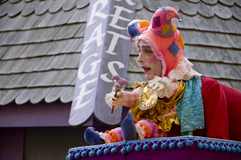 a female entertainer wearing a colorful clown outfit