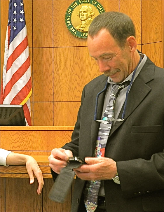 a man in a suit and tie using his phone