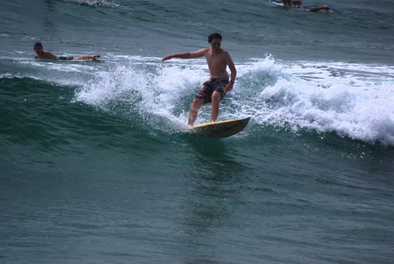 a surfer in a swimsuit catching a wave