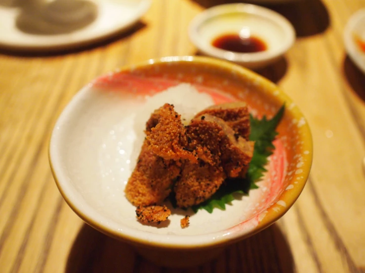 three appetizers in a small bowl on a table