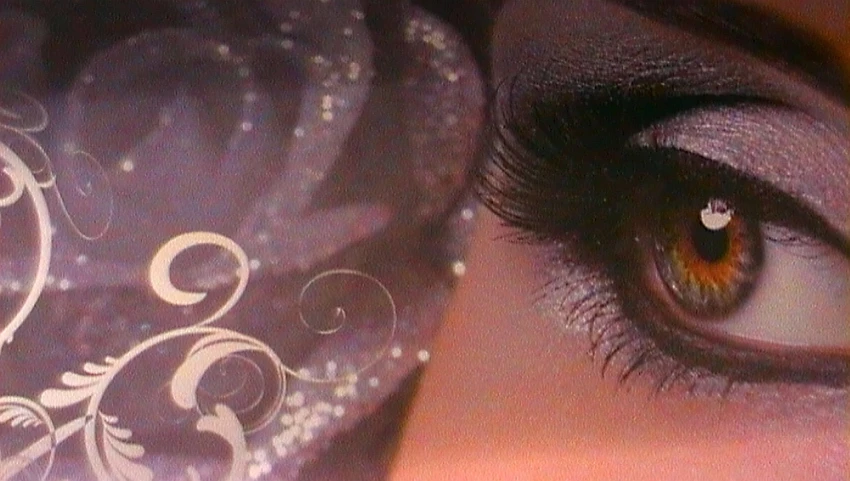 closeup of a woman's eye with a decorative background