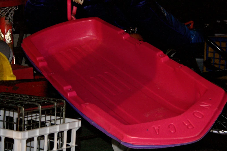 a large red plastic object sits on top of the floor