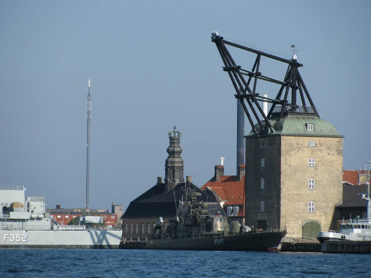 a barge sits in front of a large building on the water