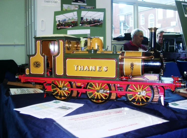 a small red train sitting on top of a table