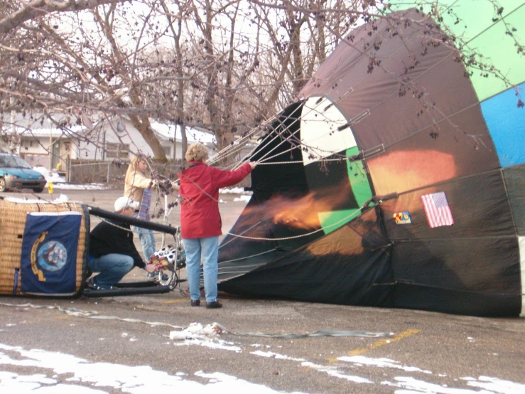 a woman with luggage and a parachute hanging from the roof of a tent