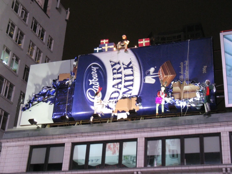 large pepsi advertit on top of building in city at night