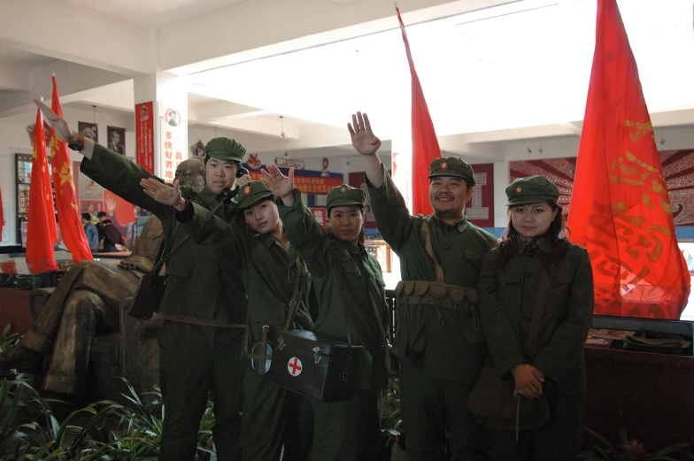 a group of soldiers in uniform holding red flags