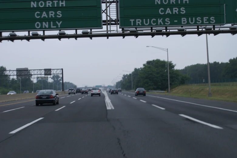 cars on a freeway with large overhead signs