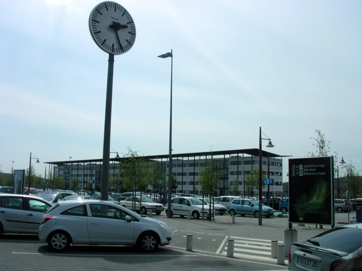 a large clock sitting on the side of a tall pole