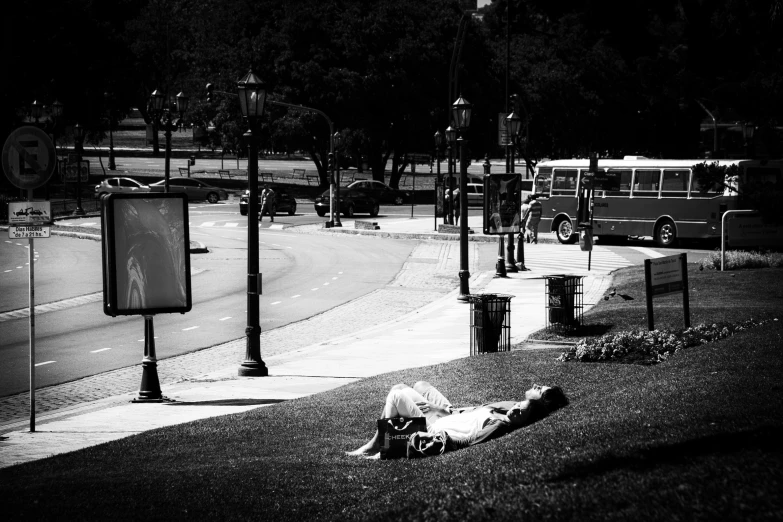 a person laying on the ground in a park