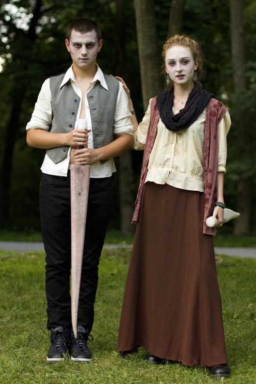 an image of two people with costumes on and one holding an umbrella