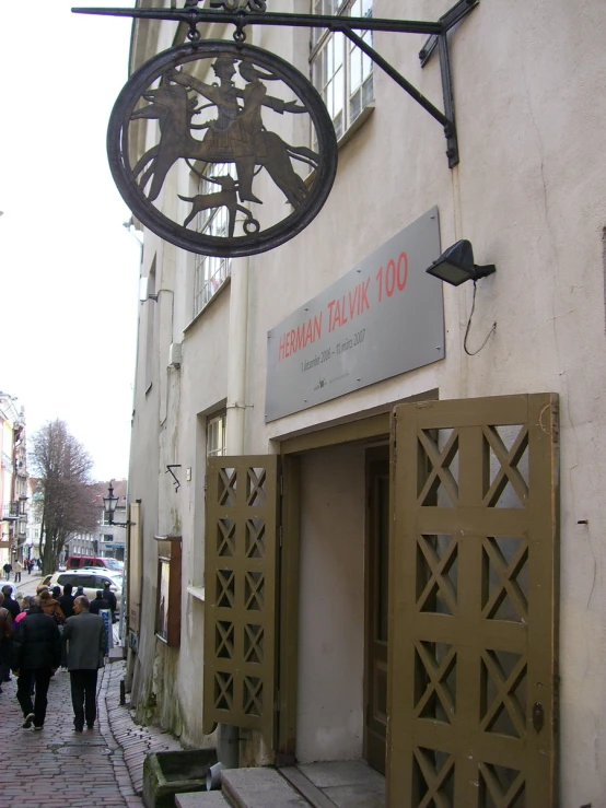 the door to the bank has a metal sculpture on top