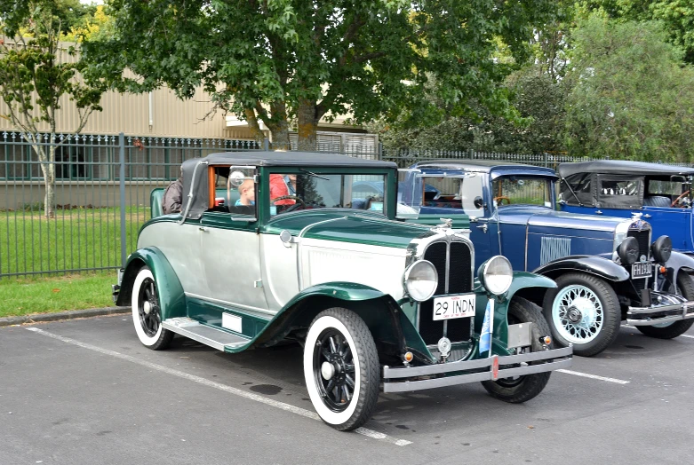 a classic car is parked in a lot