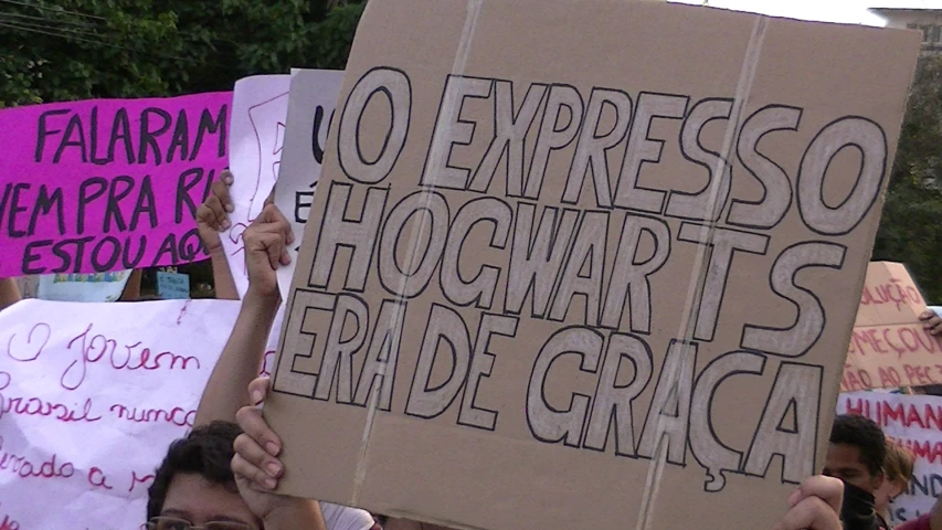 a group of people holding up signs with writing