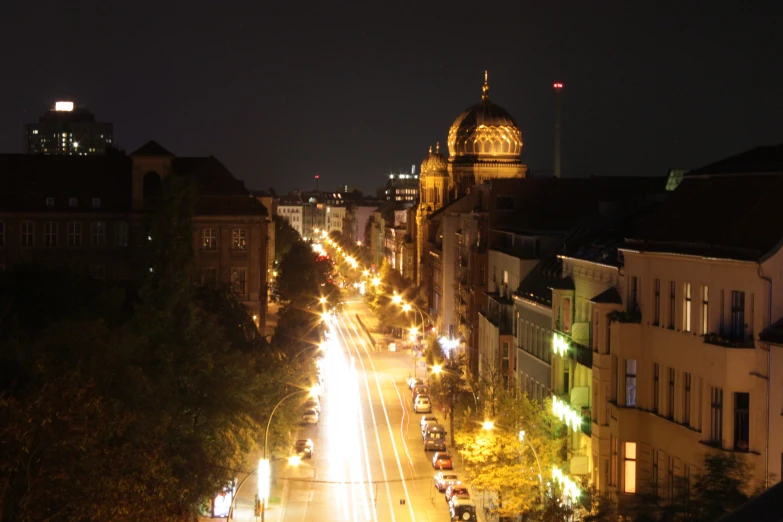 an urban city street at night time, with no traffic or people