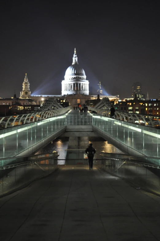 a woman standing on a bridge over a river