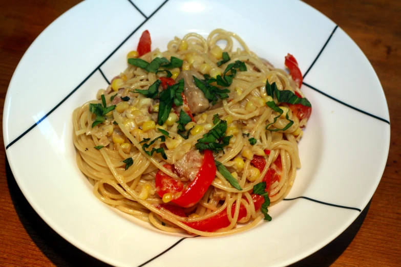 a white plate topped with spaghetti and veggies