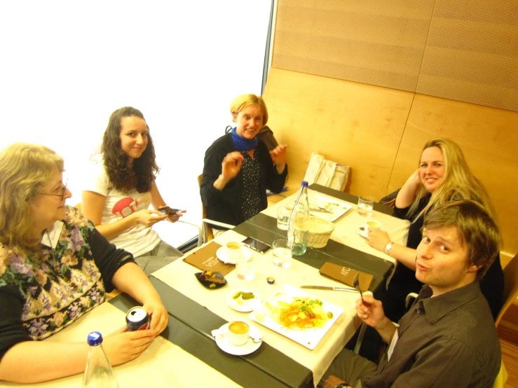 a group of people sitting at a table eating