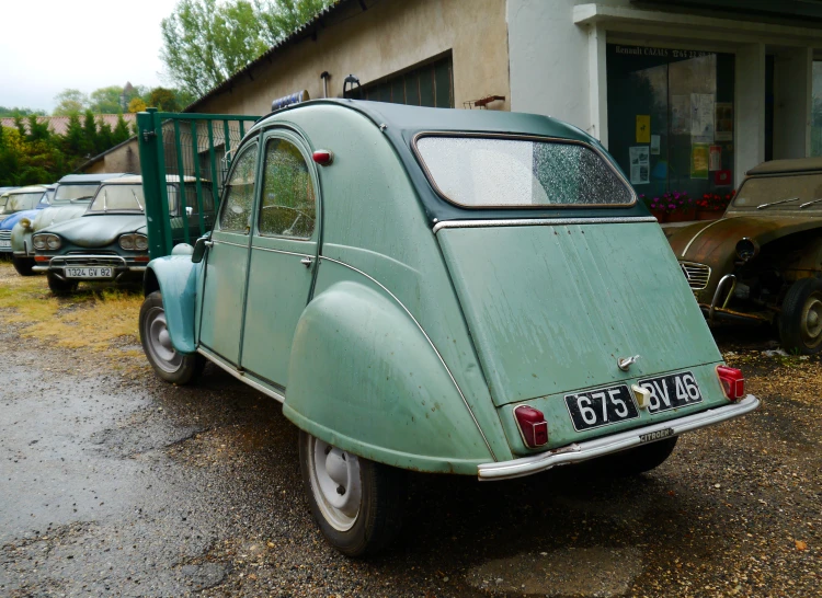 an old car parked on the side of the road