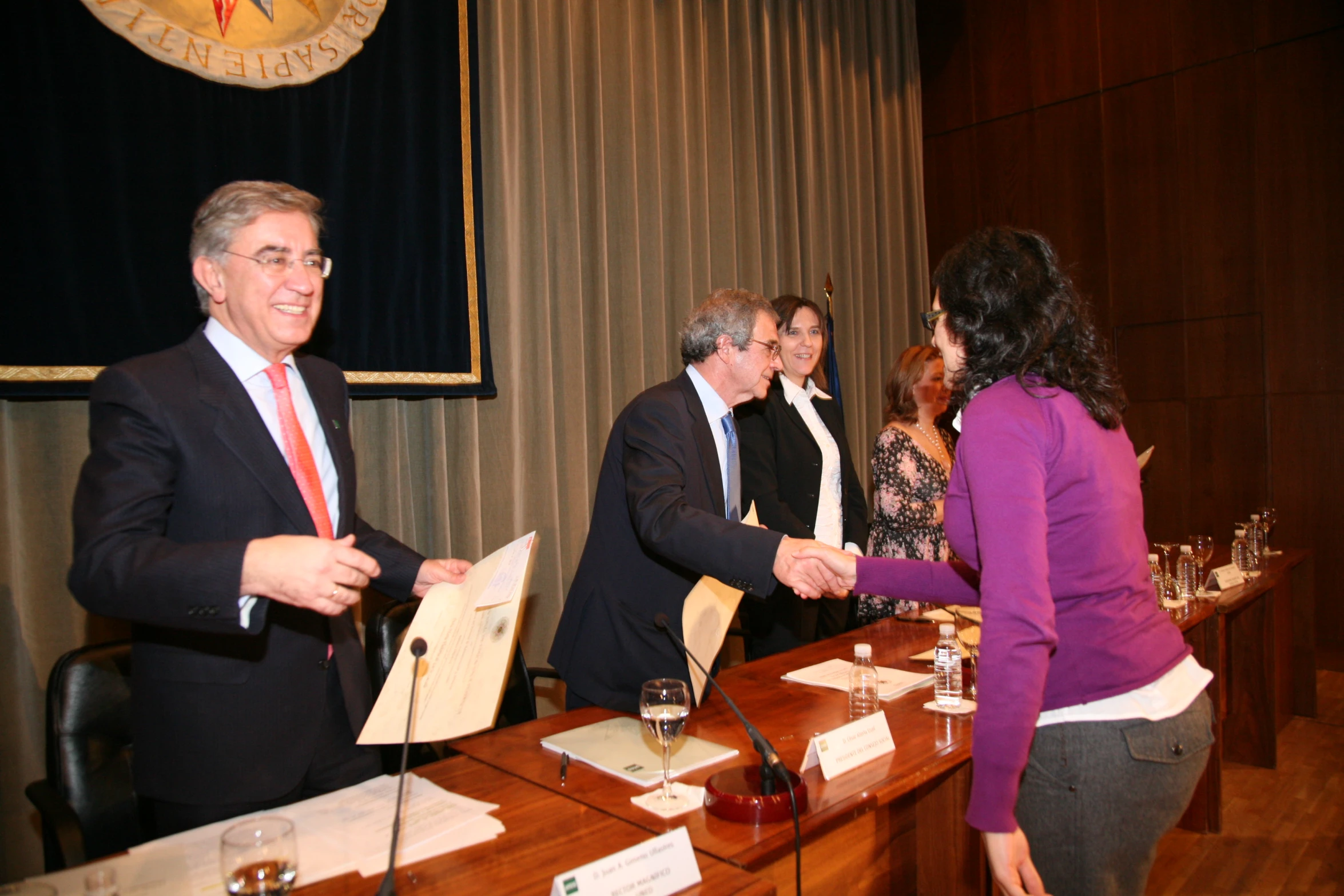 a man is handing a piece of paper to a woman